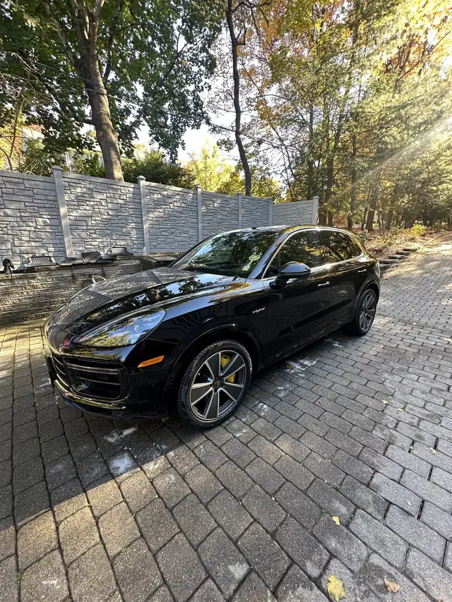 Black Porsche Cayenne in evening light