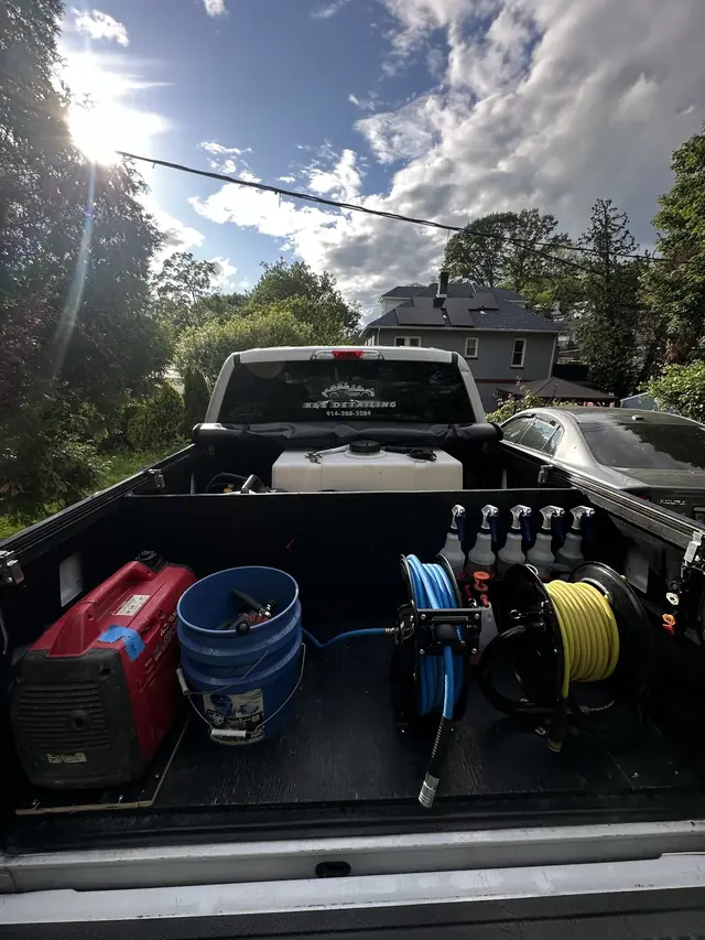 Pressure washer, generator, and water tank loaded in a truck bed