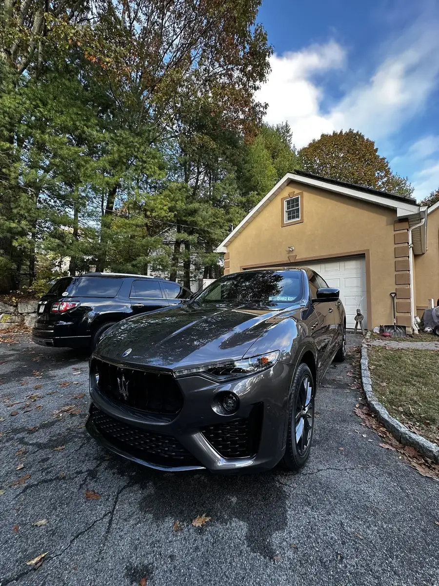 Grey Maserati Levante in a driveway after a detail