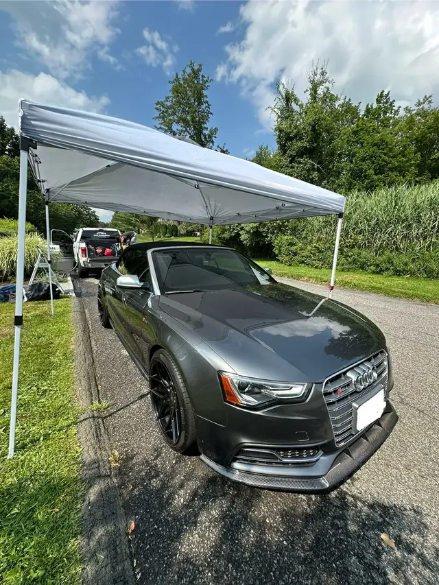 K&E pop-up tent set over a gray convertible